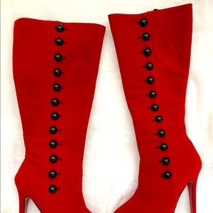 A bright red knee high tall boot.